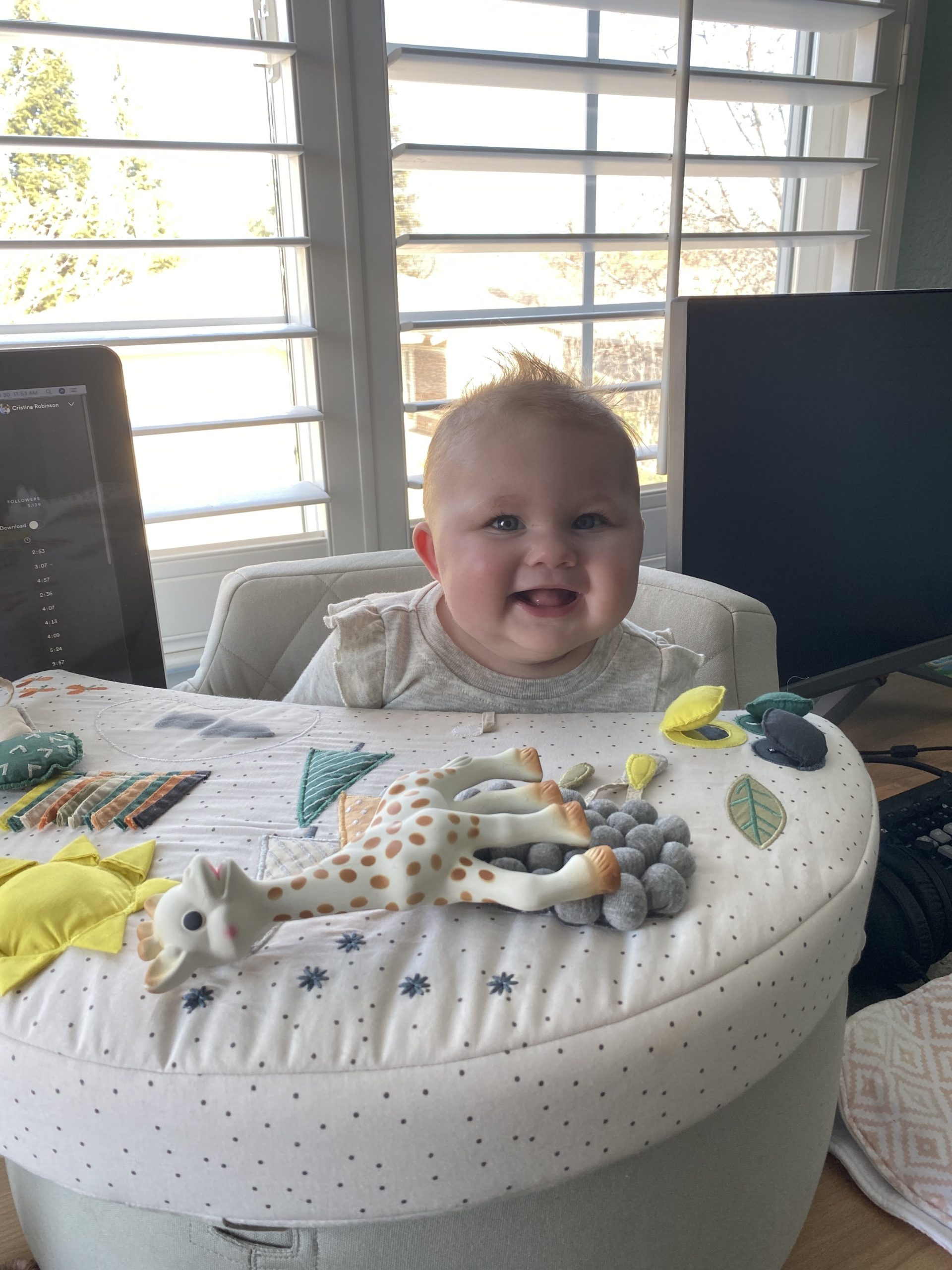 happy baby in her activity chair