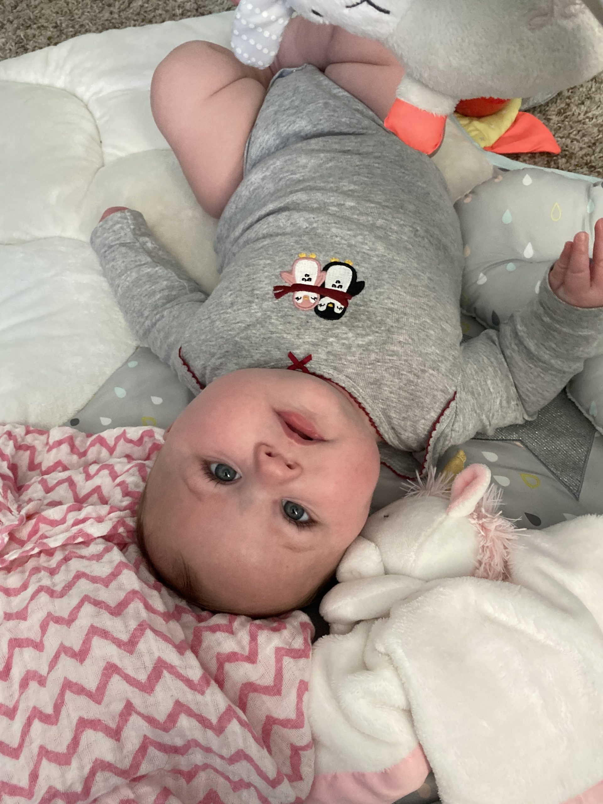 Lily upside down on her playmat
